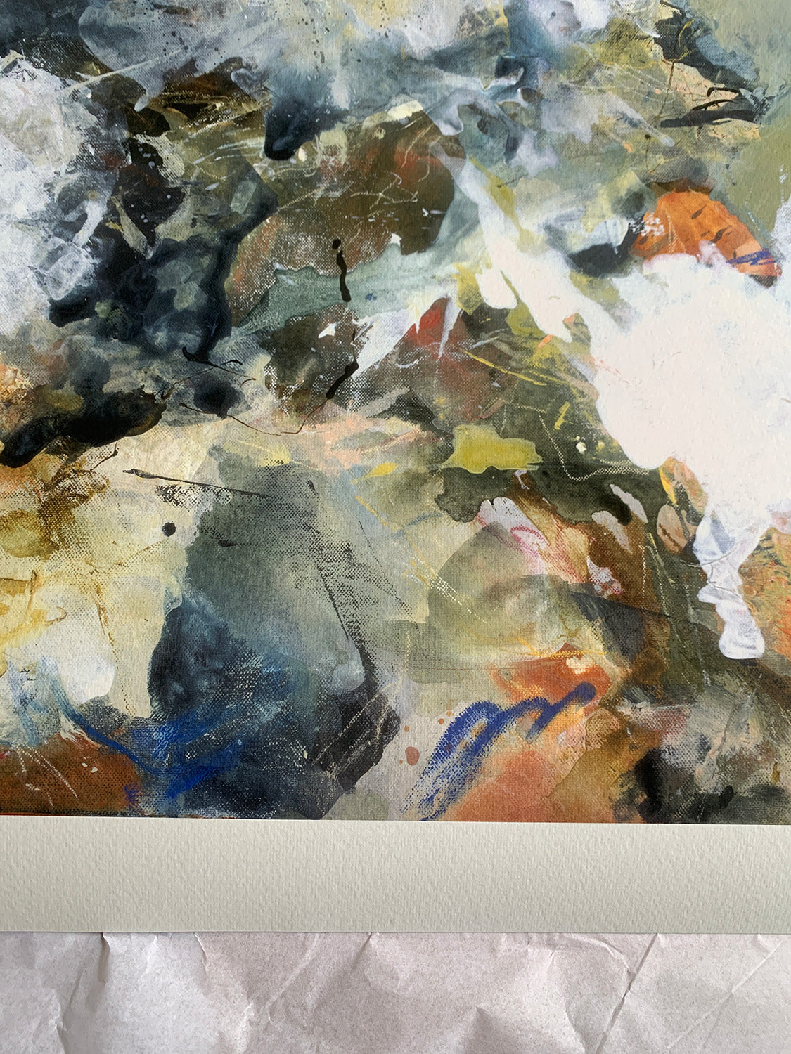 Close-up of abstract art print with a mix of white, brown, green and blue colours.