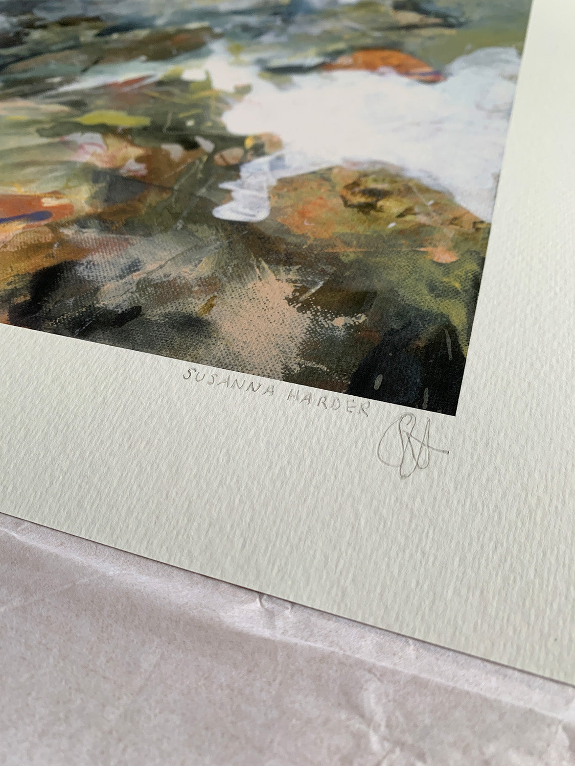Close-up of abstract art print with a mix of white, brown, green and blue colours, signed by Susanna Harder.