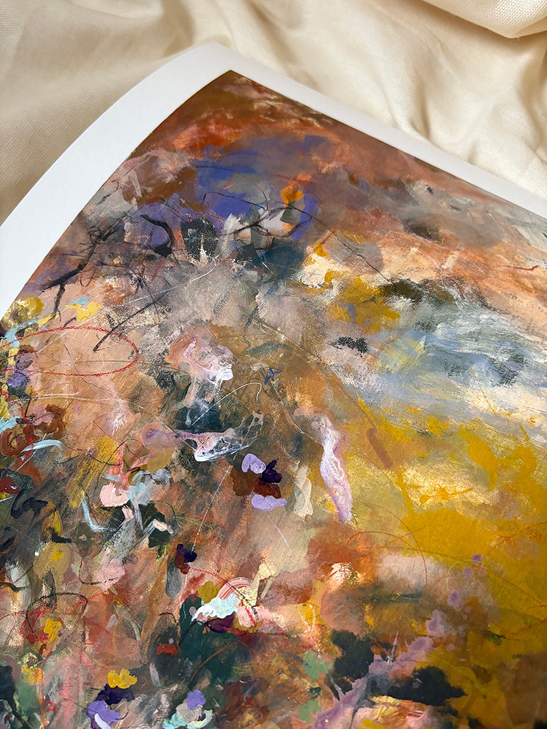 Close-up of abstract art print with warm, vibrant colours.
