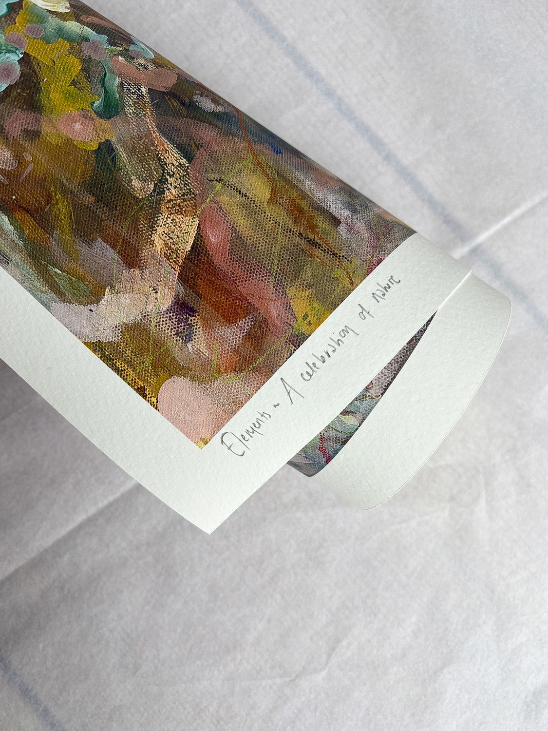 Close-up of rolled abstract art print with warm, vibrant colours.