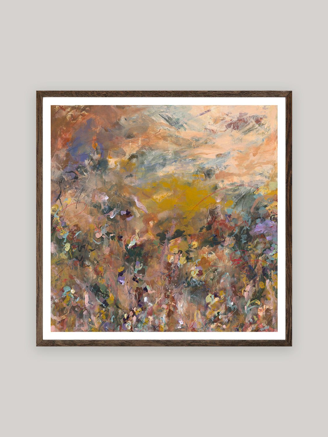 Abstract art print with warm colours in dark oak frame on a neutral background.