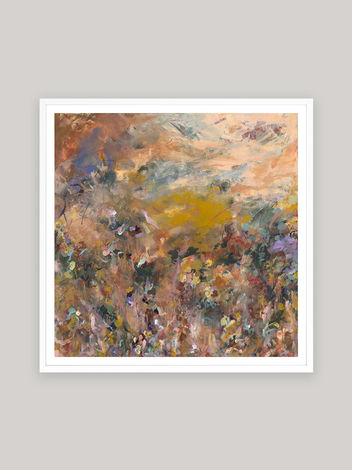 Abstract art print with warm colours in white frame on a neutral background.