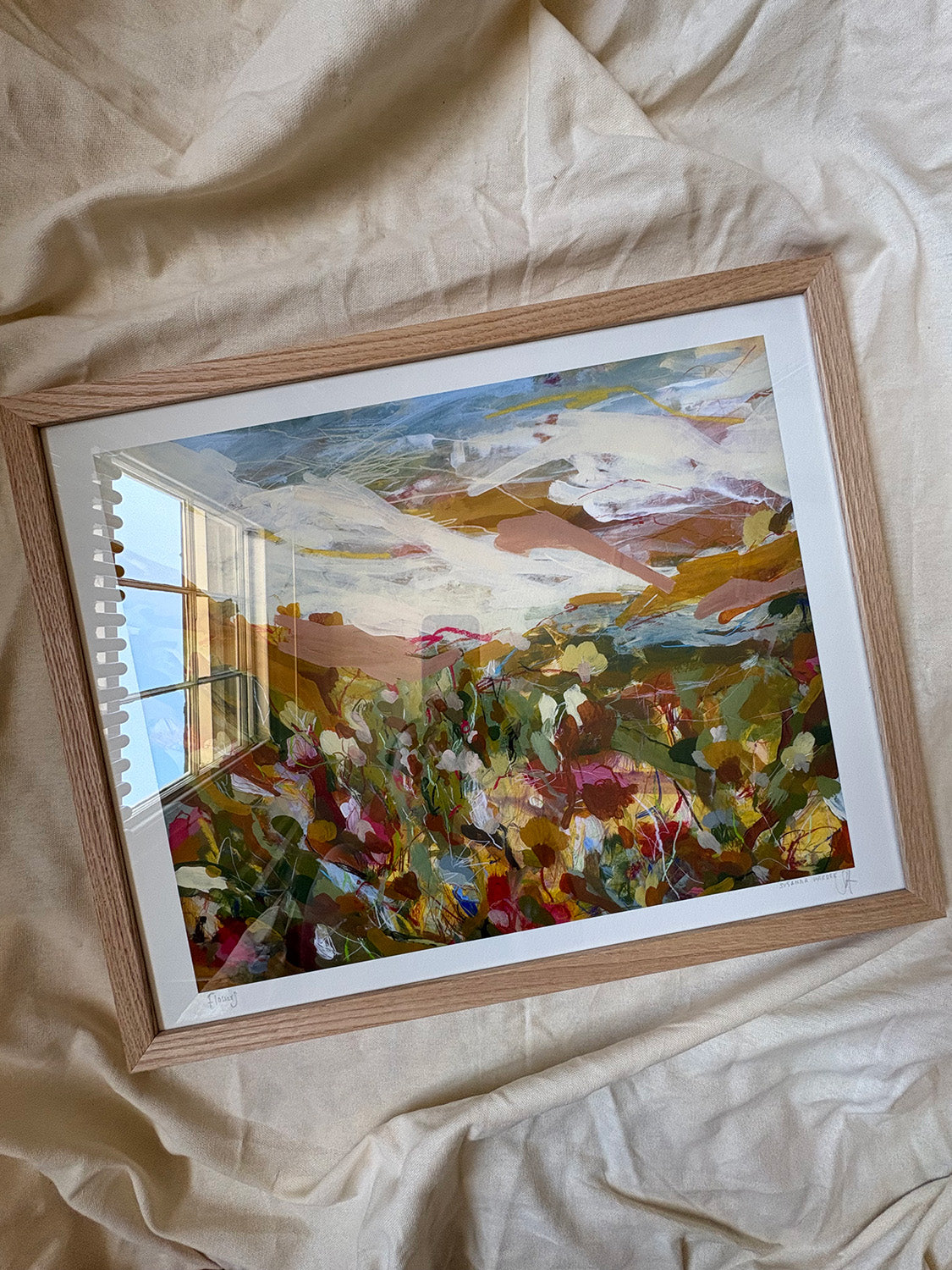 Framed abstract art print with vibrant colours on a textured surface.