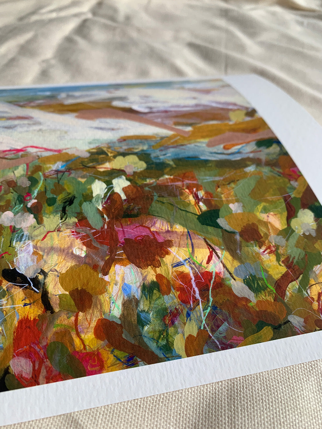 Close-up of abstract art print with vibrant colours on a textured surface.