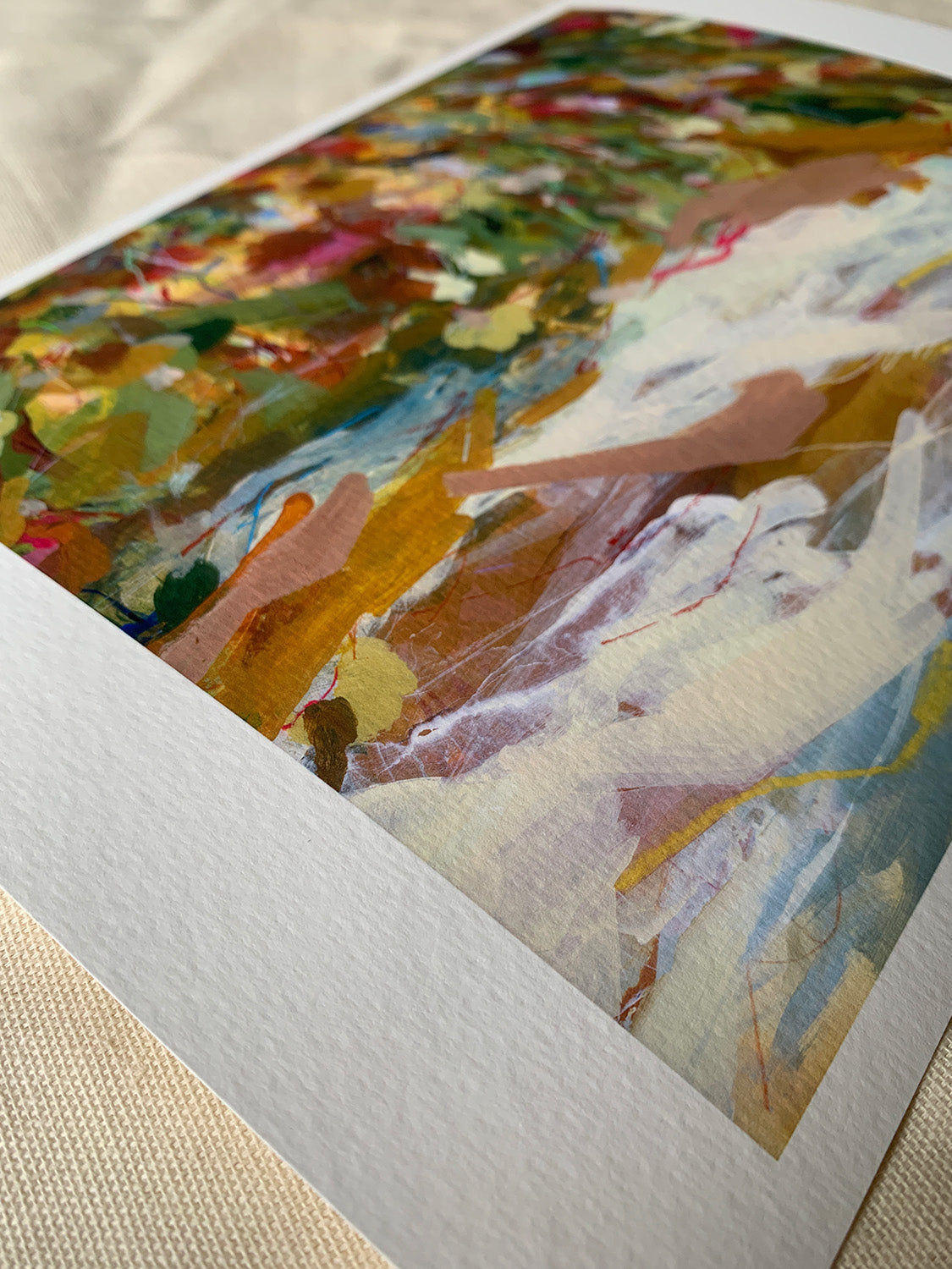 Close-up of abstract art print with vibrant colours on a textured surface.
