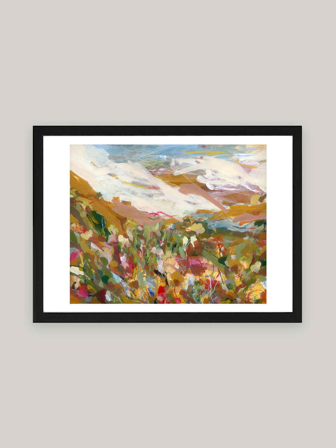 Abstract art print with vibrant colours in black frame on a neutral background.