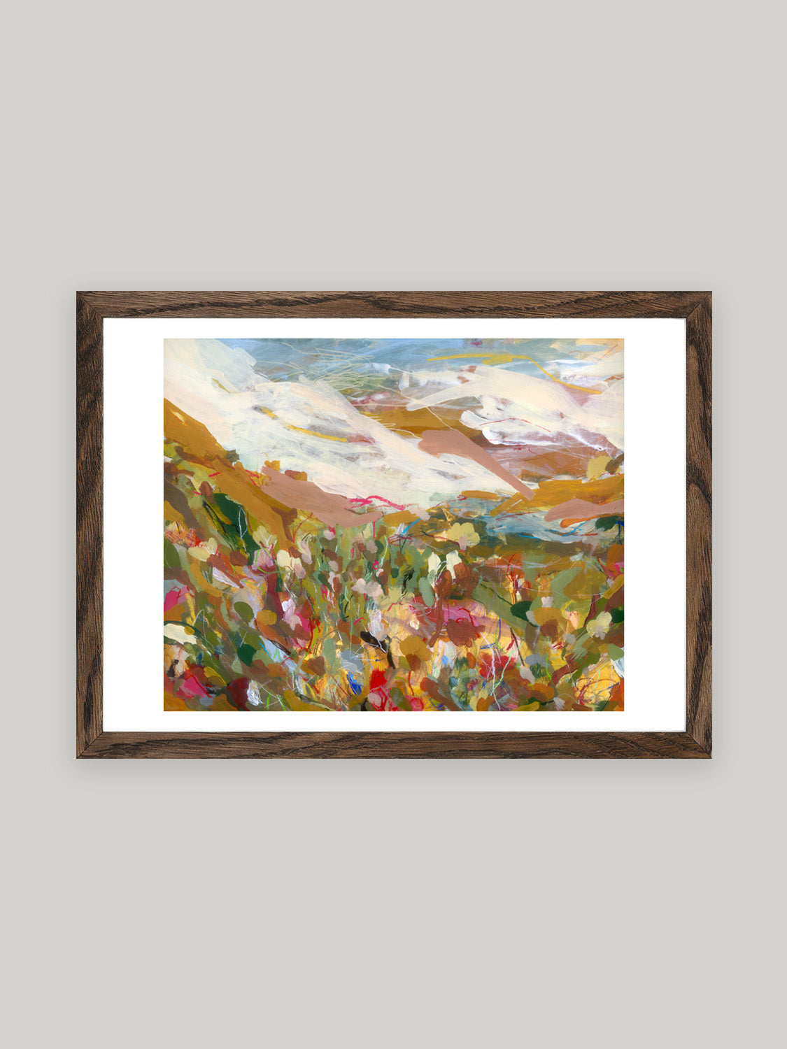 Abstract art print with vibrant colours in dark oak frame on a neutral background.