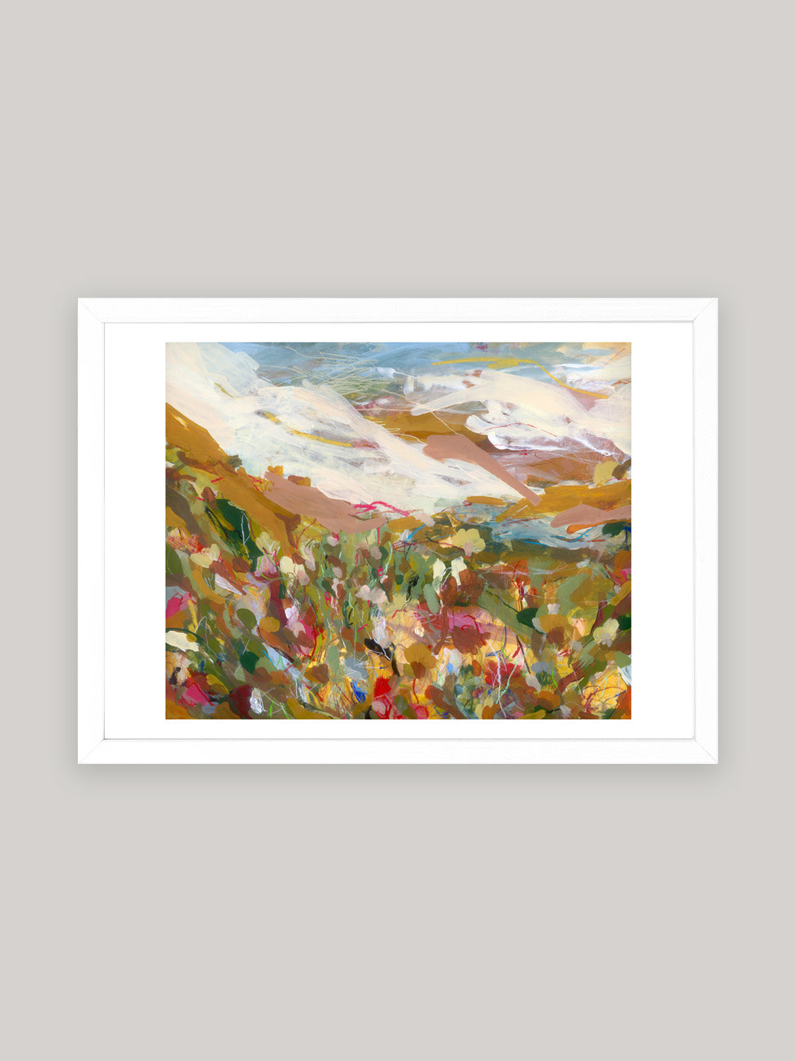 Abstract art print with vibrant colours in white frame on a neutral background.