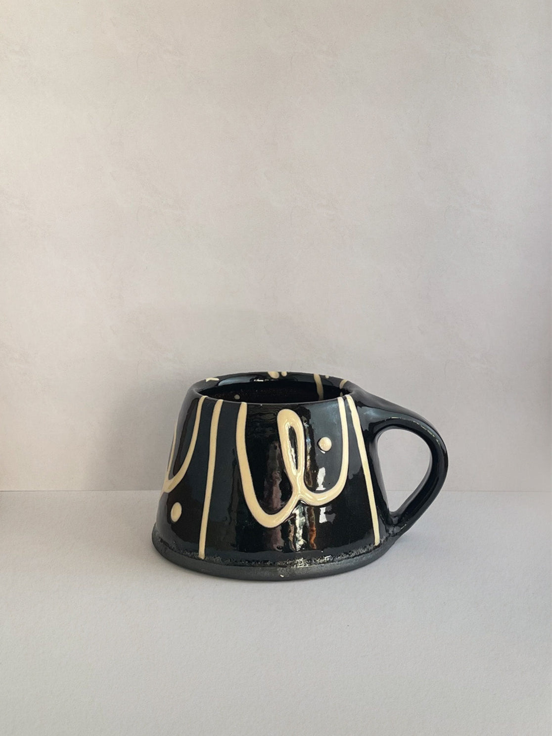 Handmade slipware mug - left.