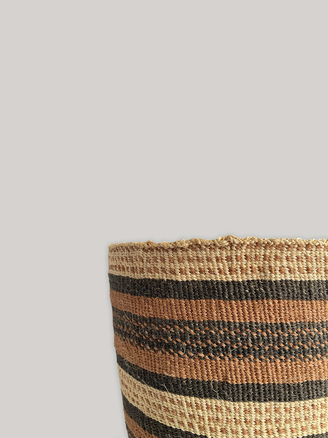 Medium handwoven sisal basket in black, natural and rust - detail.