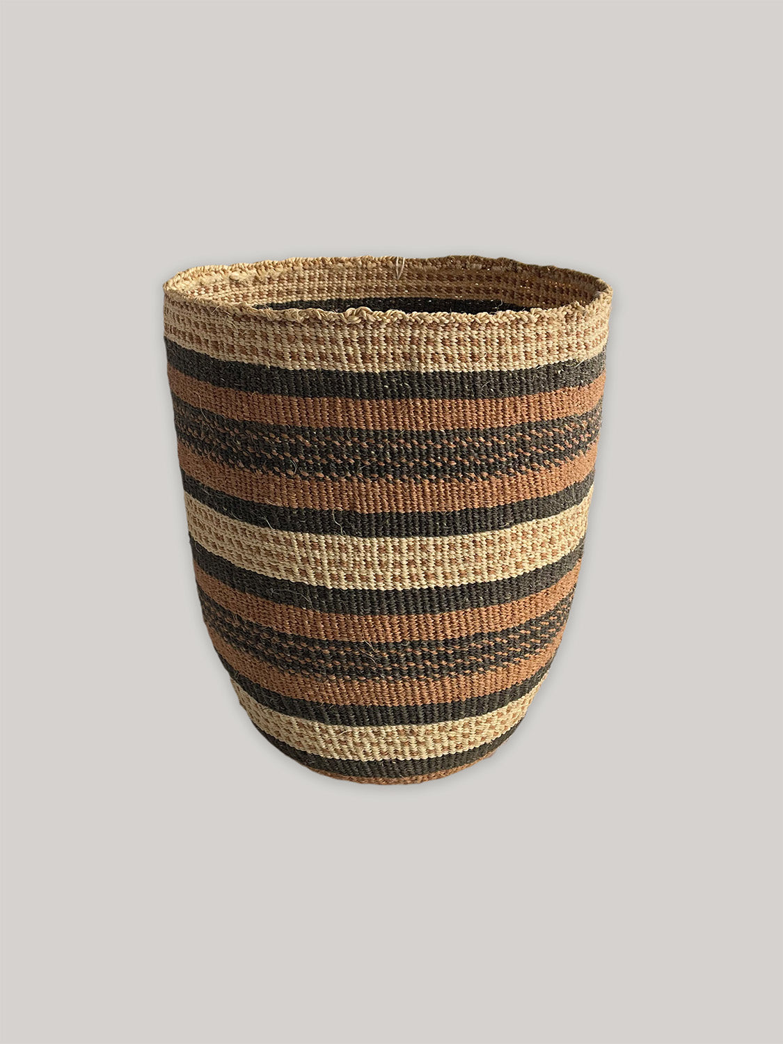 Medium handwoven sisal basket in black, natural and rust - front.
