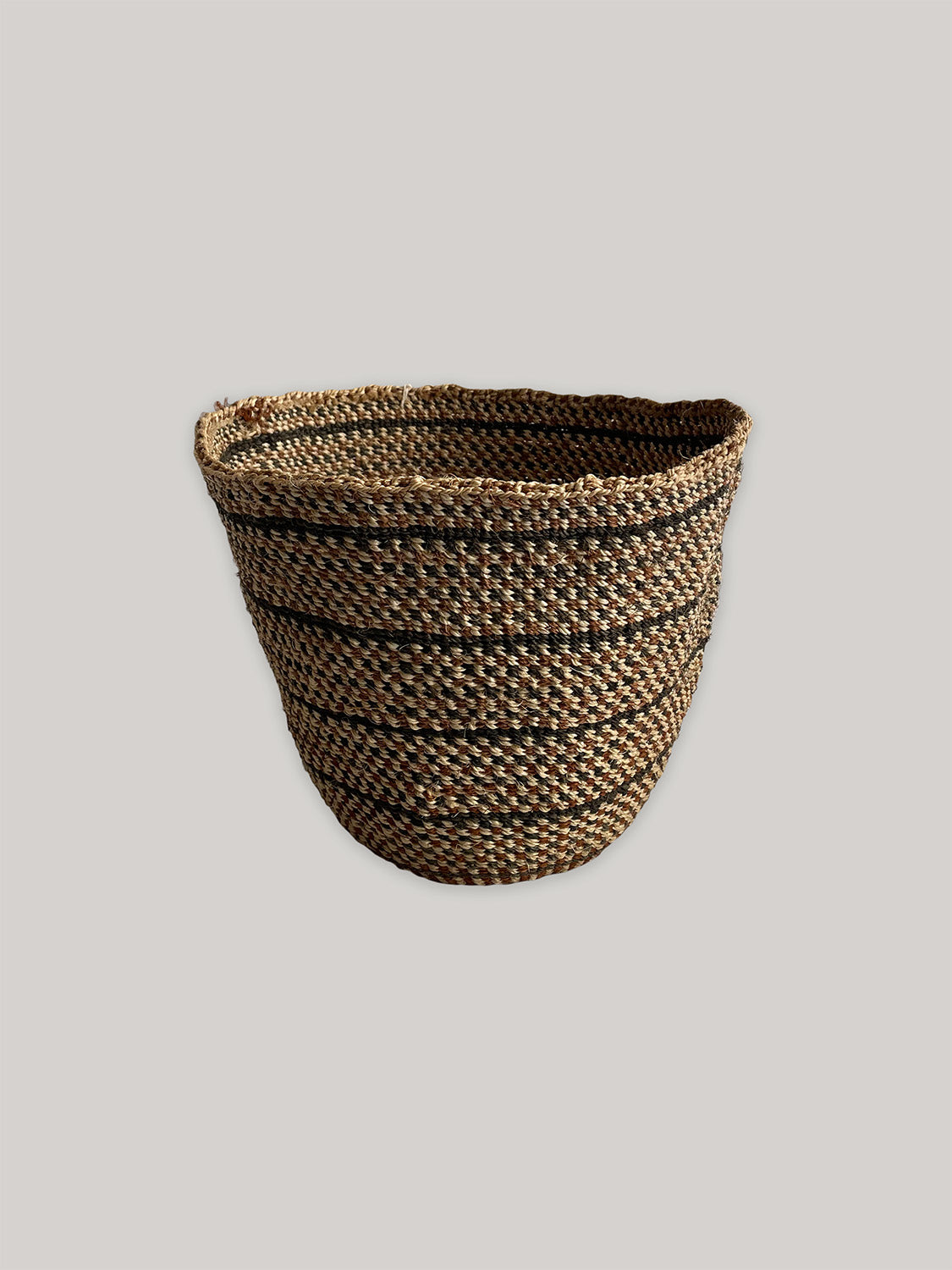 Small handwoven sisal basket in black, natural and rust - front.