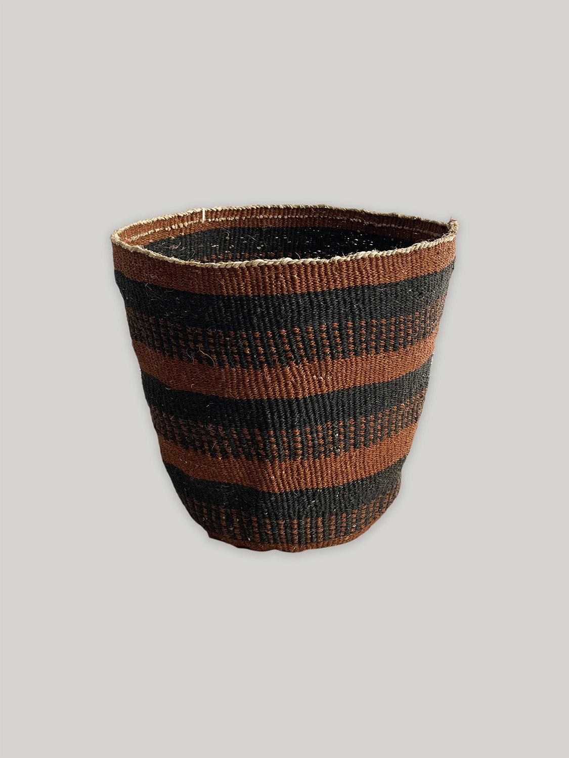 Medium handwoven sisal basket in black and rust - front.