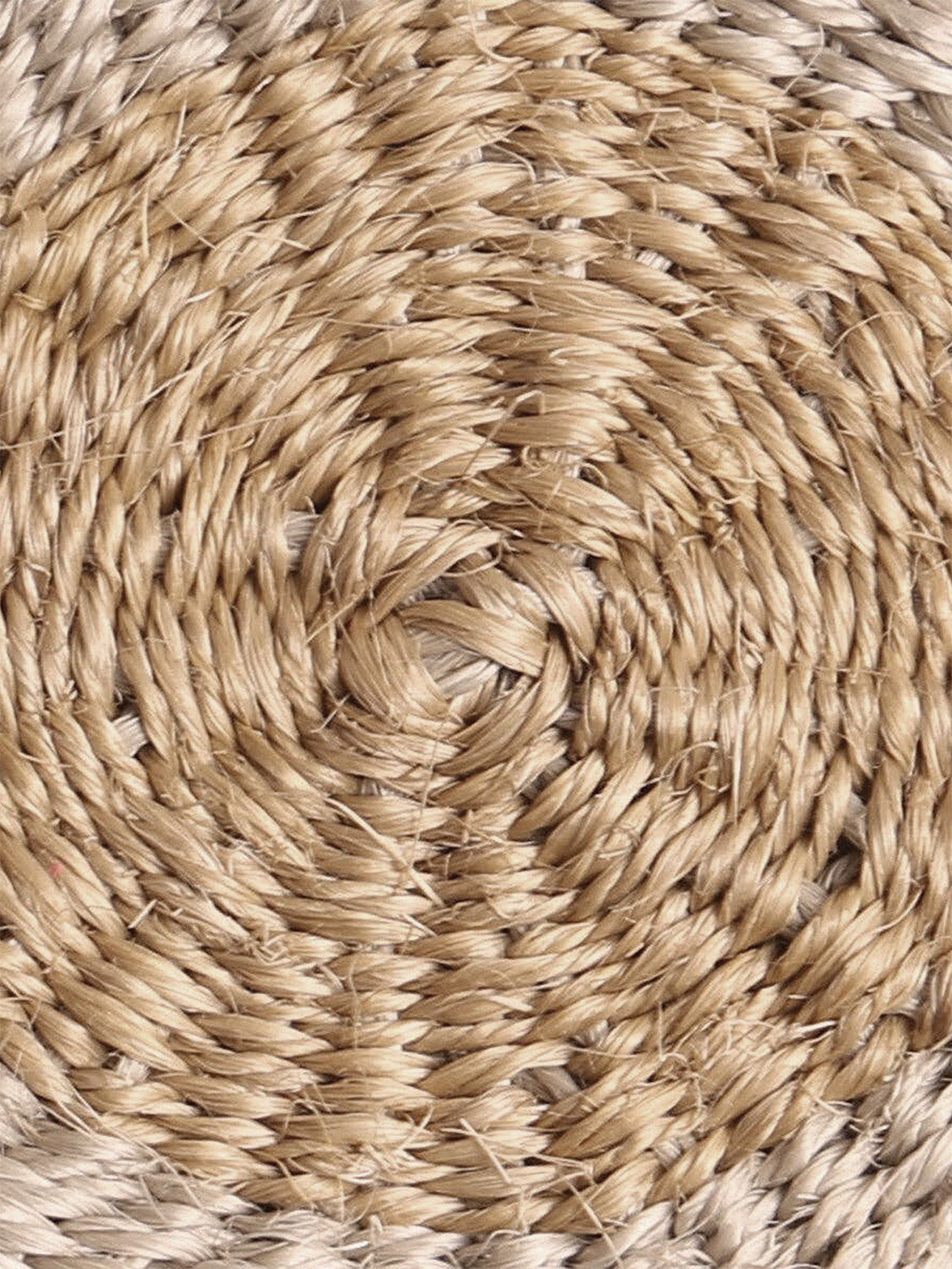 Close-up of round handwoven sisal coaster.