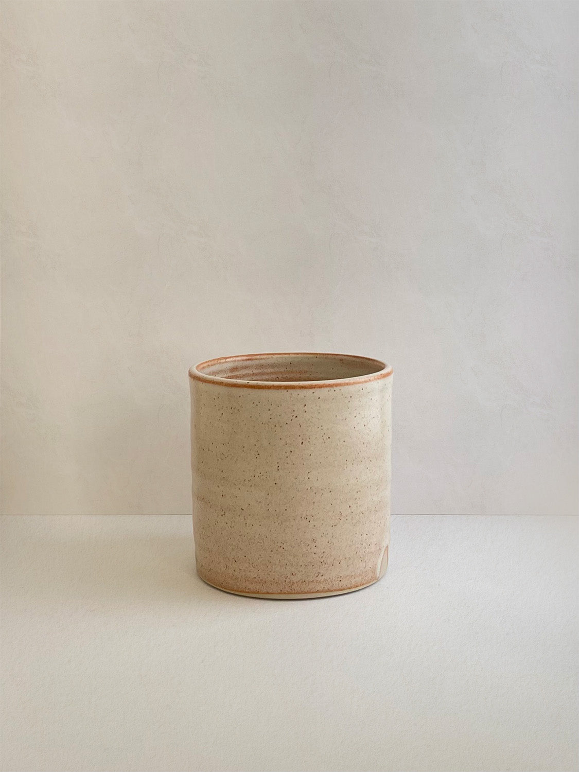Rust ceramic mug on a neutral background - front view.