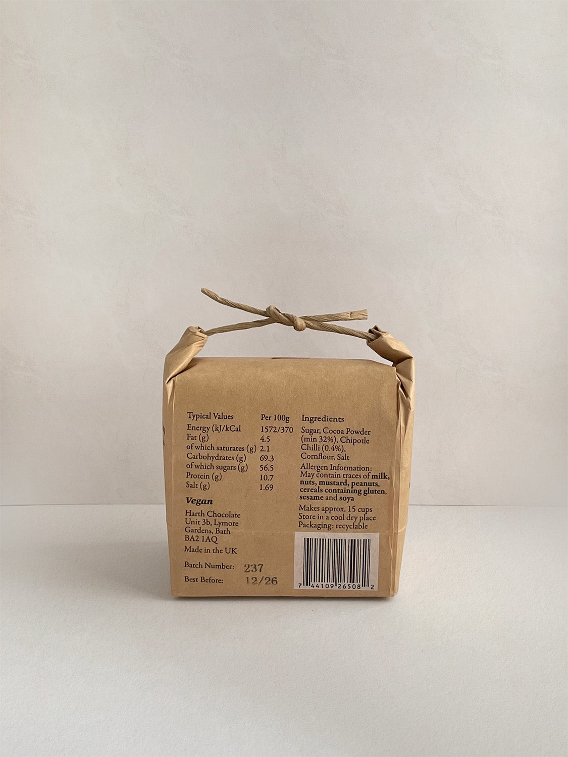 Kraft paper packaging with nutritional information on a neutral background.