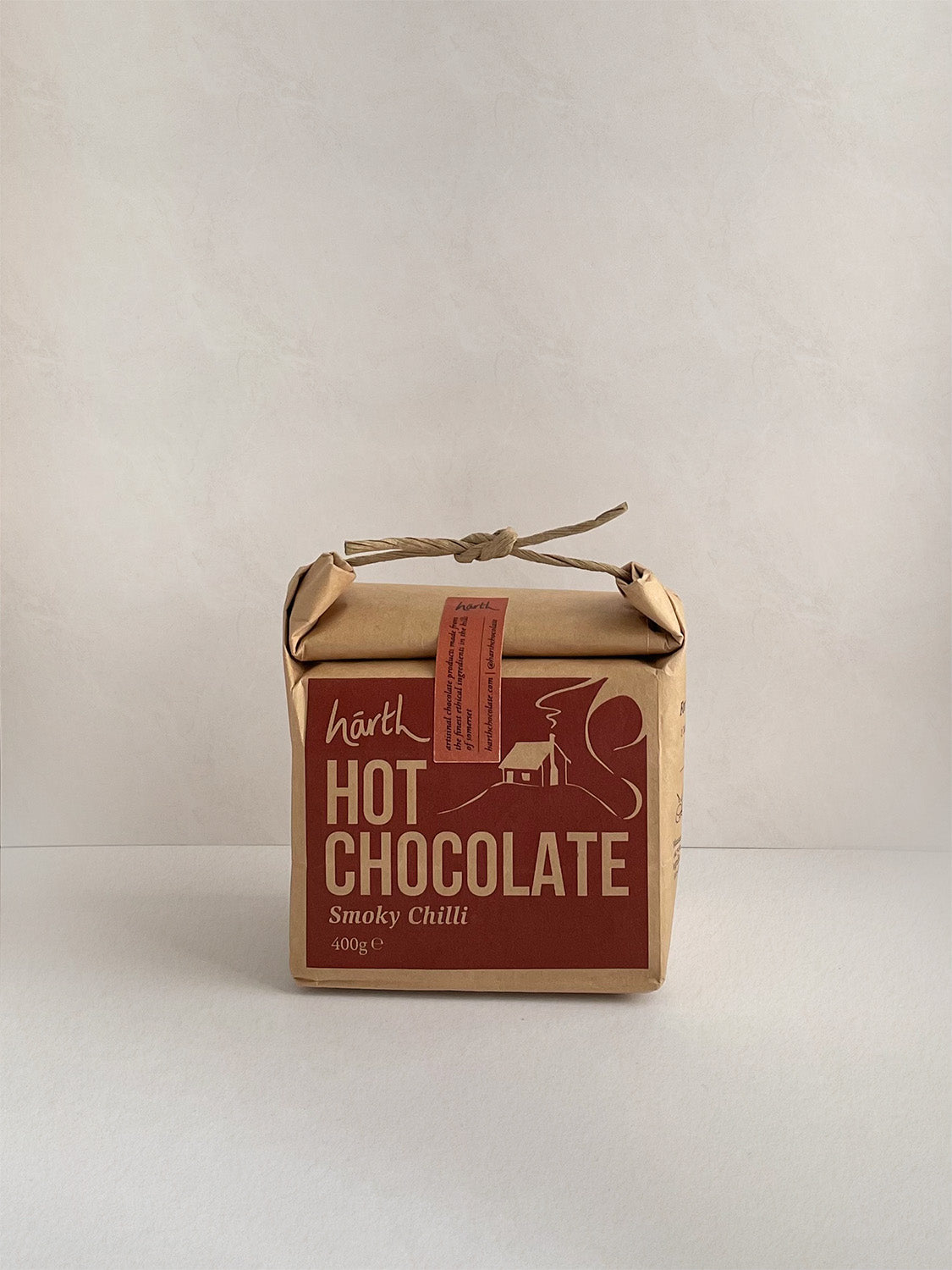 Box of hot chocolate with a red label on a neutral background.