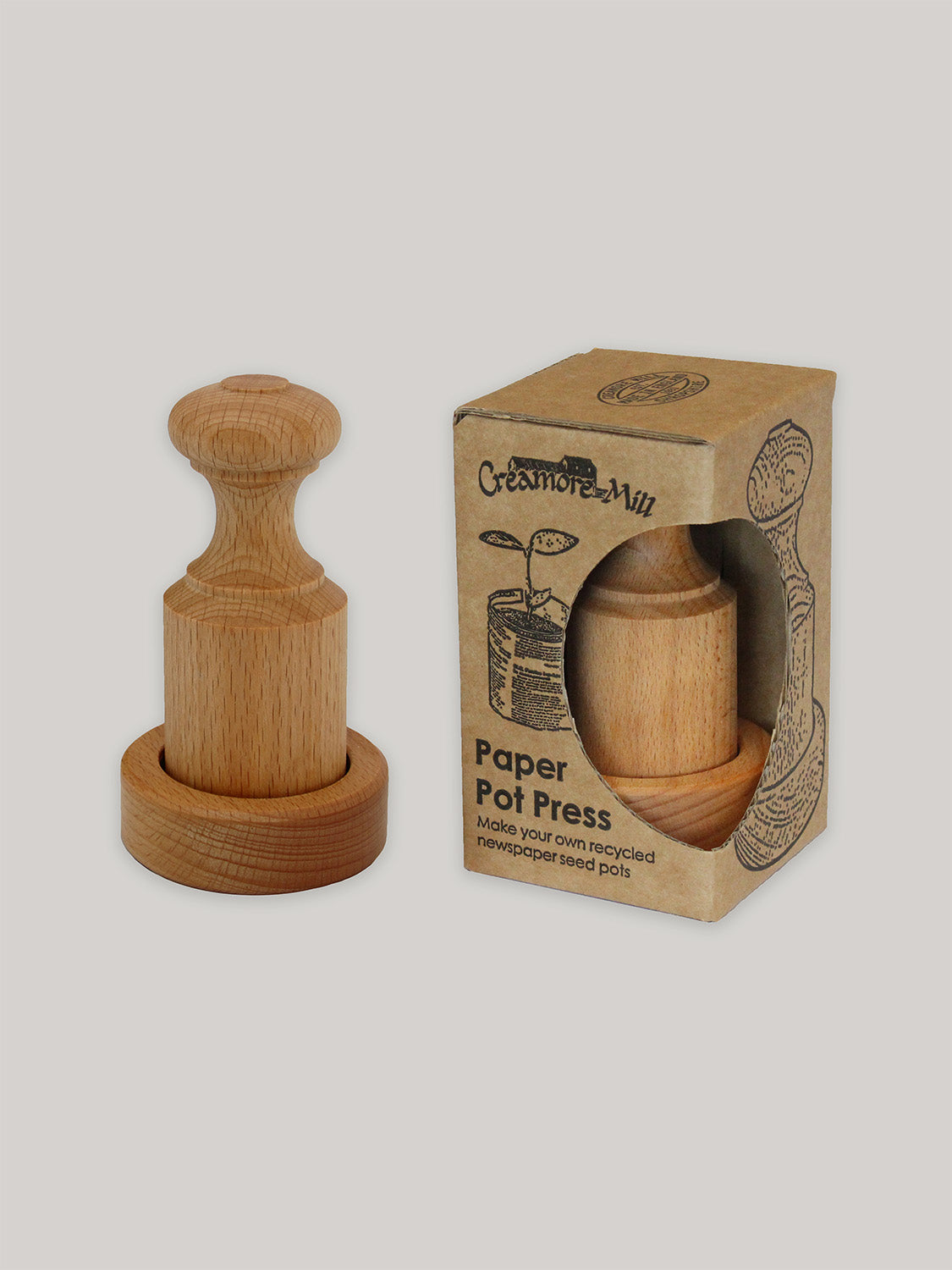 Beech paper pot press with box on a neutral background.