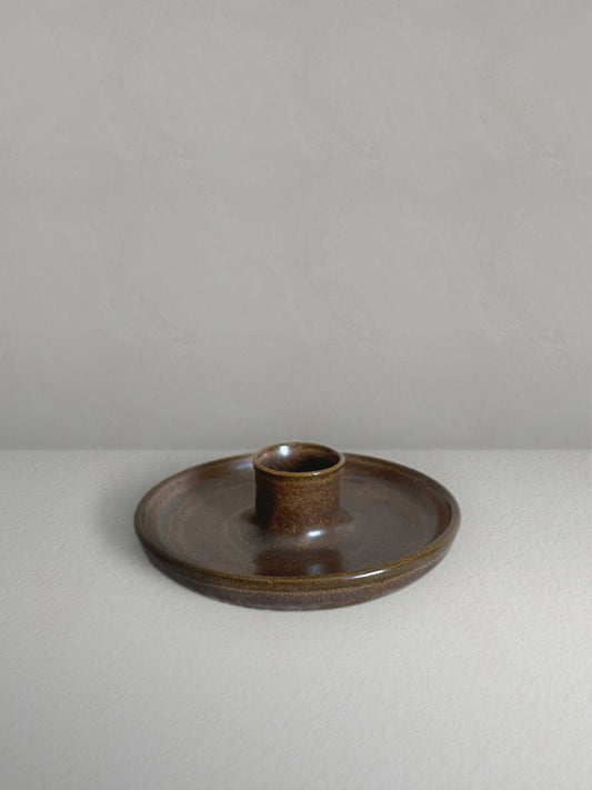 Low round ceramic candle holder in brown glaze - front.