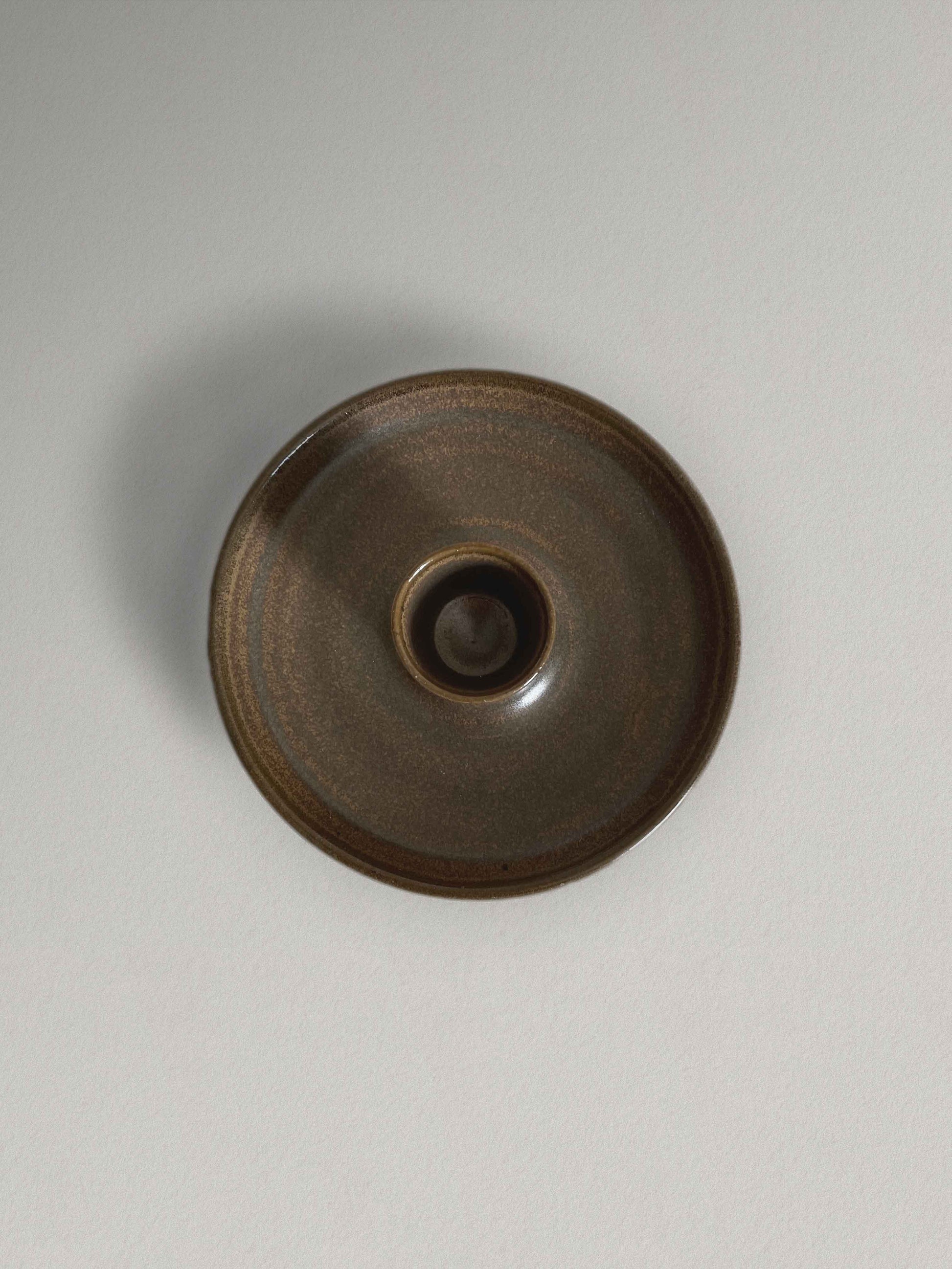 Low round ceramic candle holder in brown glaze - top.