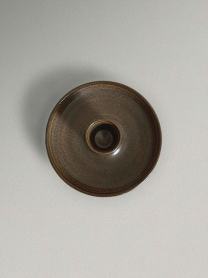 Low round ceramic candle holder in brown glaze - top.