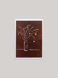 Botanical Christmas card with a vase of festive foliage design on a dark red background.