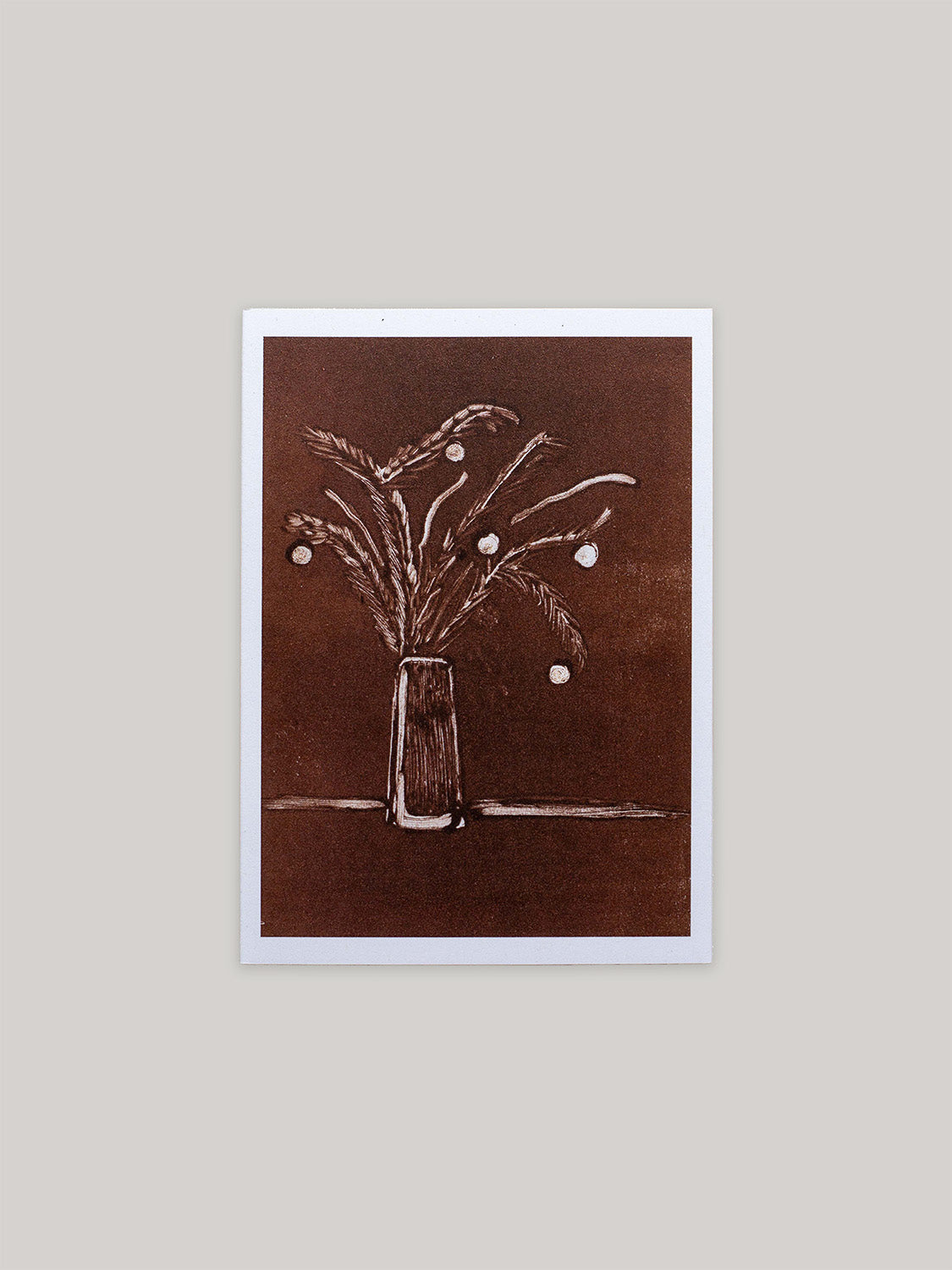 Botanical Christmas card with a vase of festive foliage design on a dark red background.
