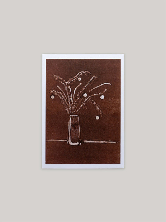 Botanical Christmas card with a vase of festive foliage design on a dark red background.