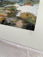 Close-up of abstract art print with a mix of white, brown, green and blue colours, signed by Susanna Harder.