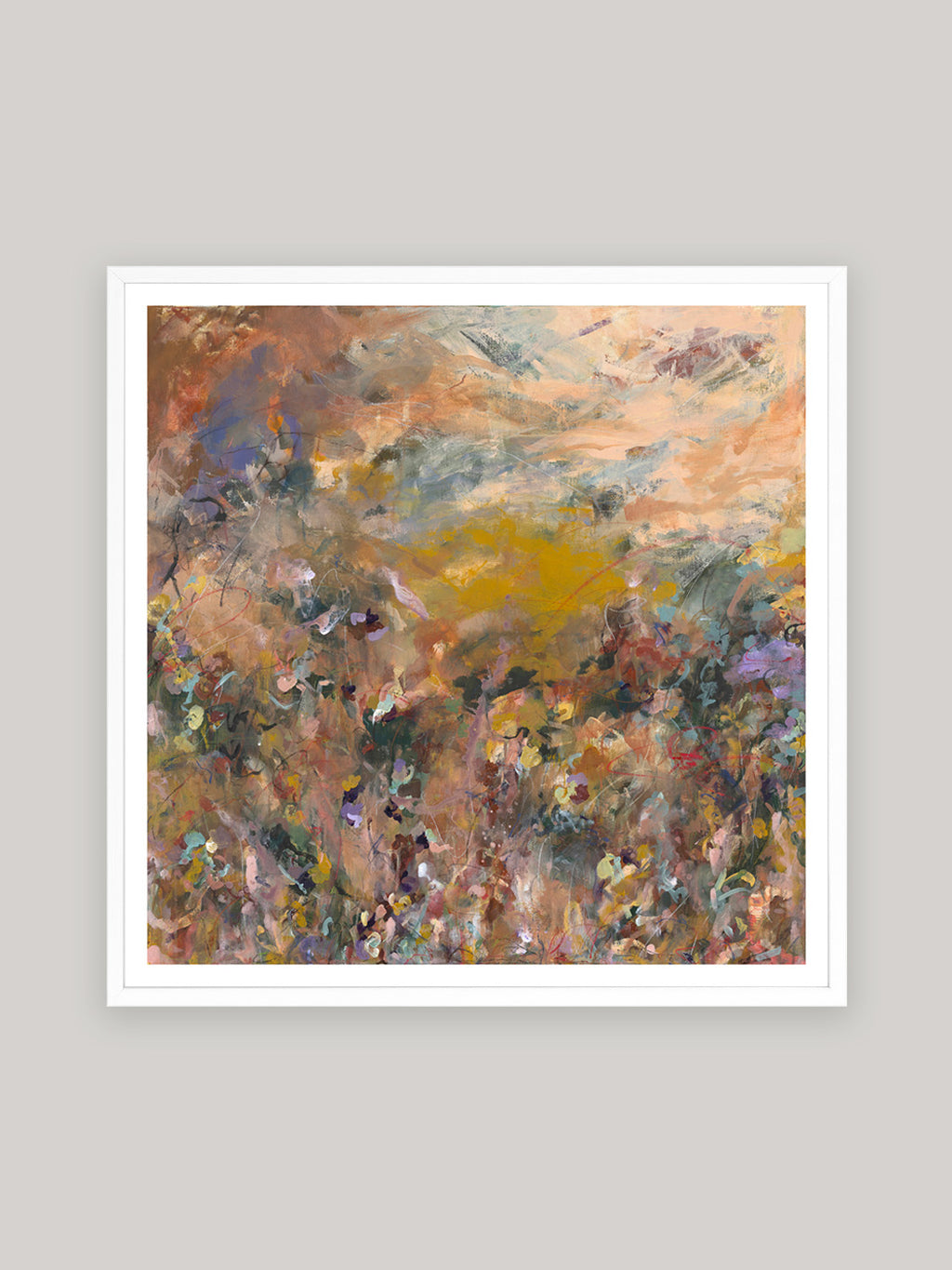 Abstract art print with warm colours in white frame on a neutral background.