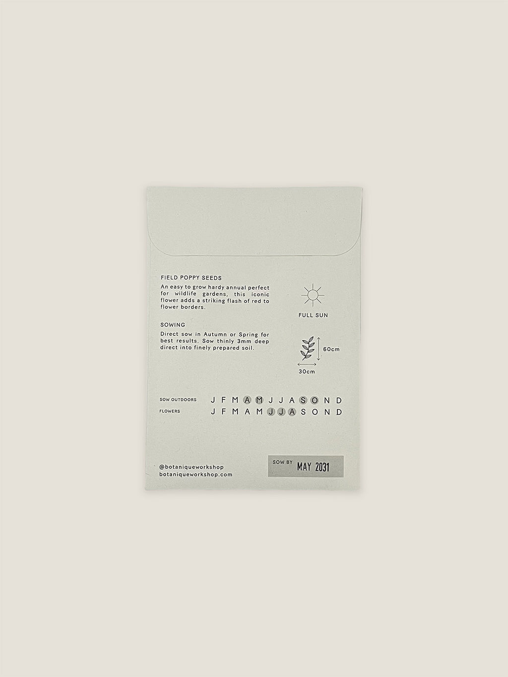 Back of Field Poppy seed packet with text and growing instructions on a neutral background.