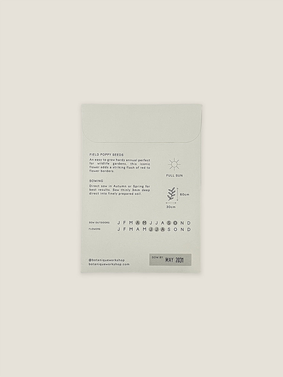 Back of Field Poppy seed packet with text and growing instructions on a neutral background.