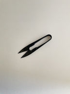 A pair of black metal pruning snips with a spring-loaded design, on a neutral background.