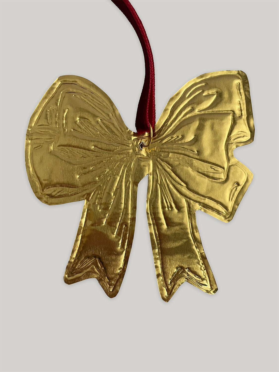 Gold tin bow handmade Christmas decoration with red velvet ribbon - back.