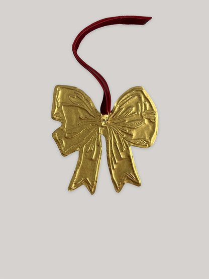 Gold tin bow handmade Christmas decoration with red velvet ribbon - front.