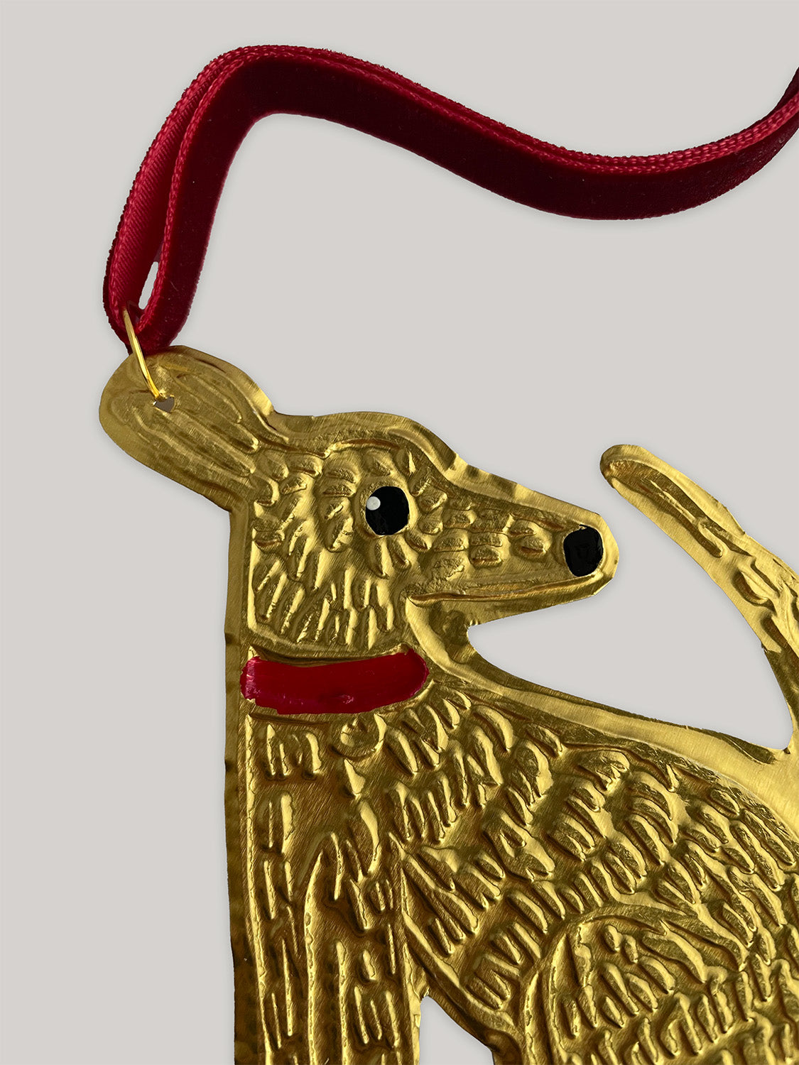 Gold tin dog handmade Christmas decoration with red velvet ribbon - detail.