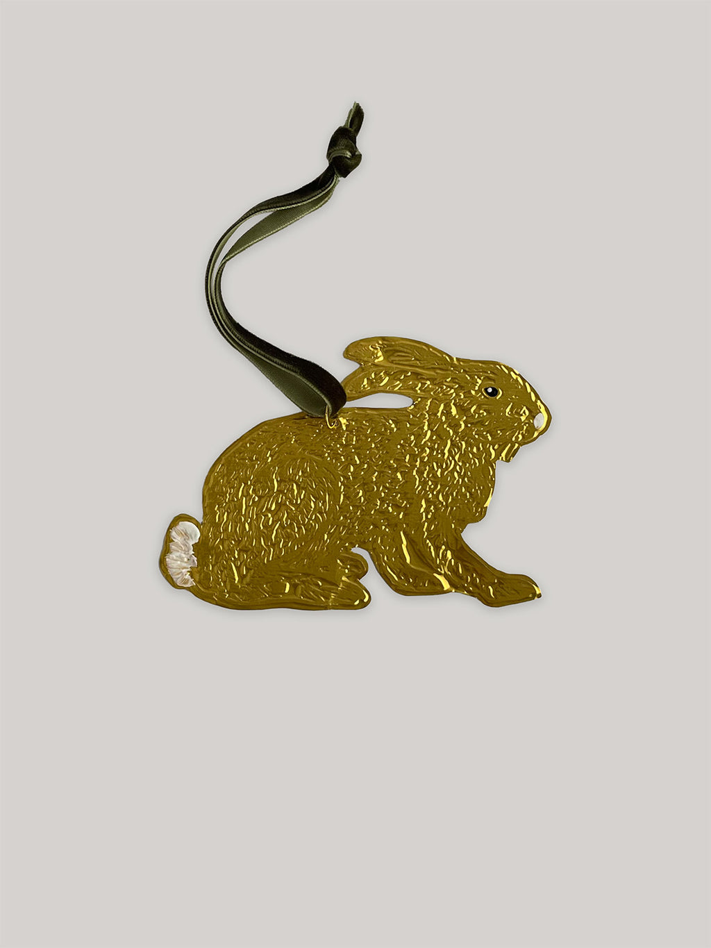 Gold tin hare handmade ornament with green velvet ribbon on a neutral background - front.