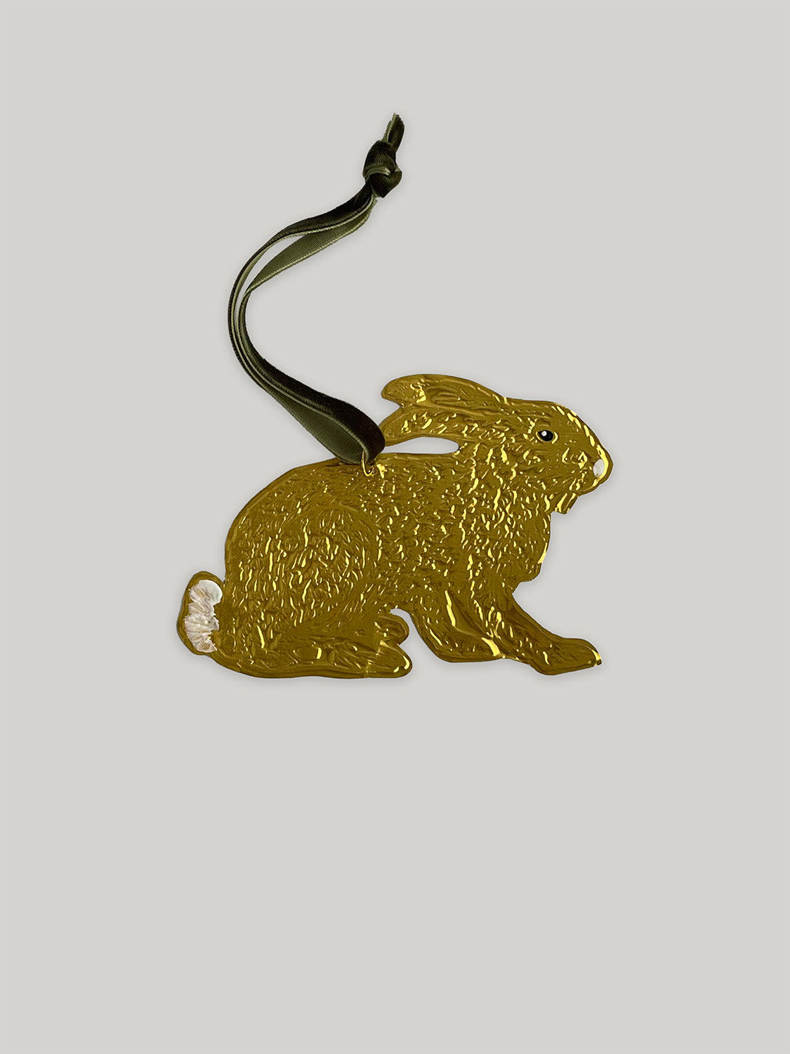 Gold tin hare handmade ornament with green velvet ribbon on a neutral background - front.
