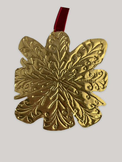 Gold tin snowflake handmade Christmas decoration with red velvet ribbon - back.