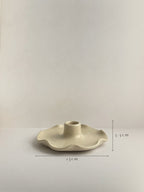 A handmade ceramic candle holder with a softly frilled base and a central cylindrical stem, with dimensions shown, on a neutral background.