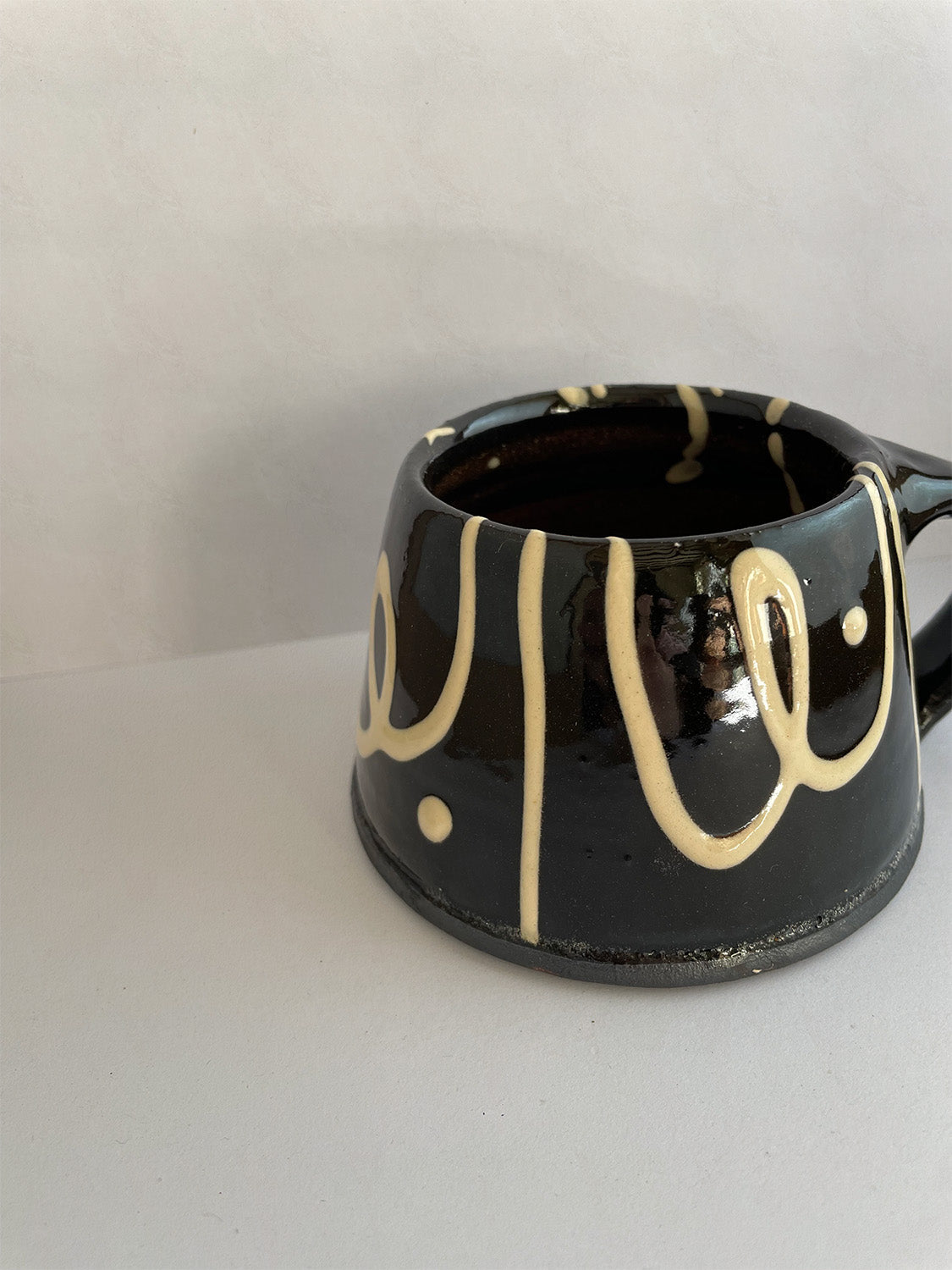 Handmade slipware mug - front detail.
