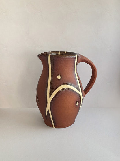 Handmade slipware small jug - left.