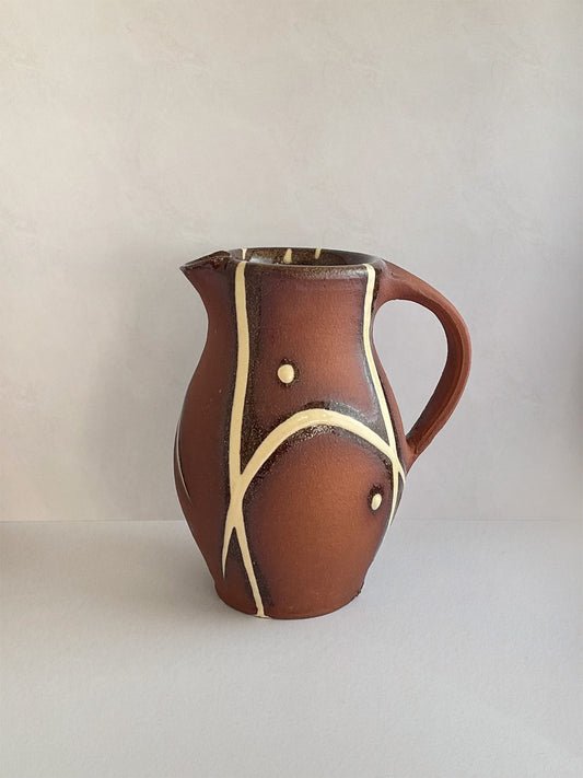 Handmade slipware small jug - left.