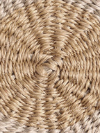 Close-up of round handwoven sisal coaster.