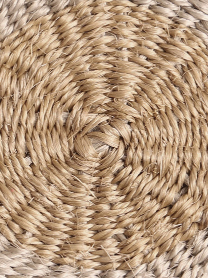 Close-up of round handwoven sisal coaster.