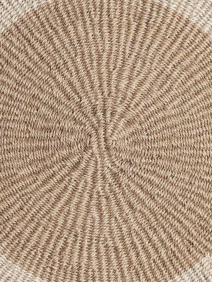 Close-up of round handwoven sisal placemat.