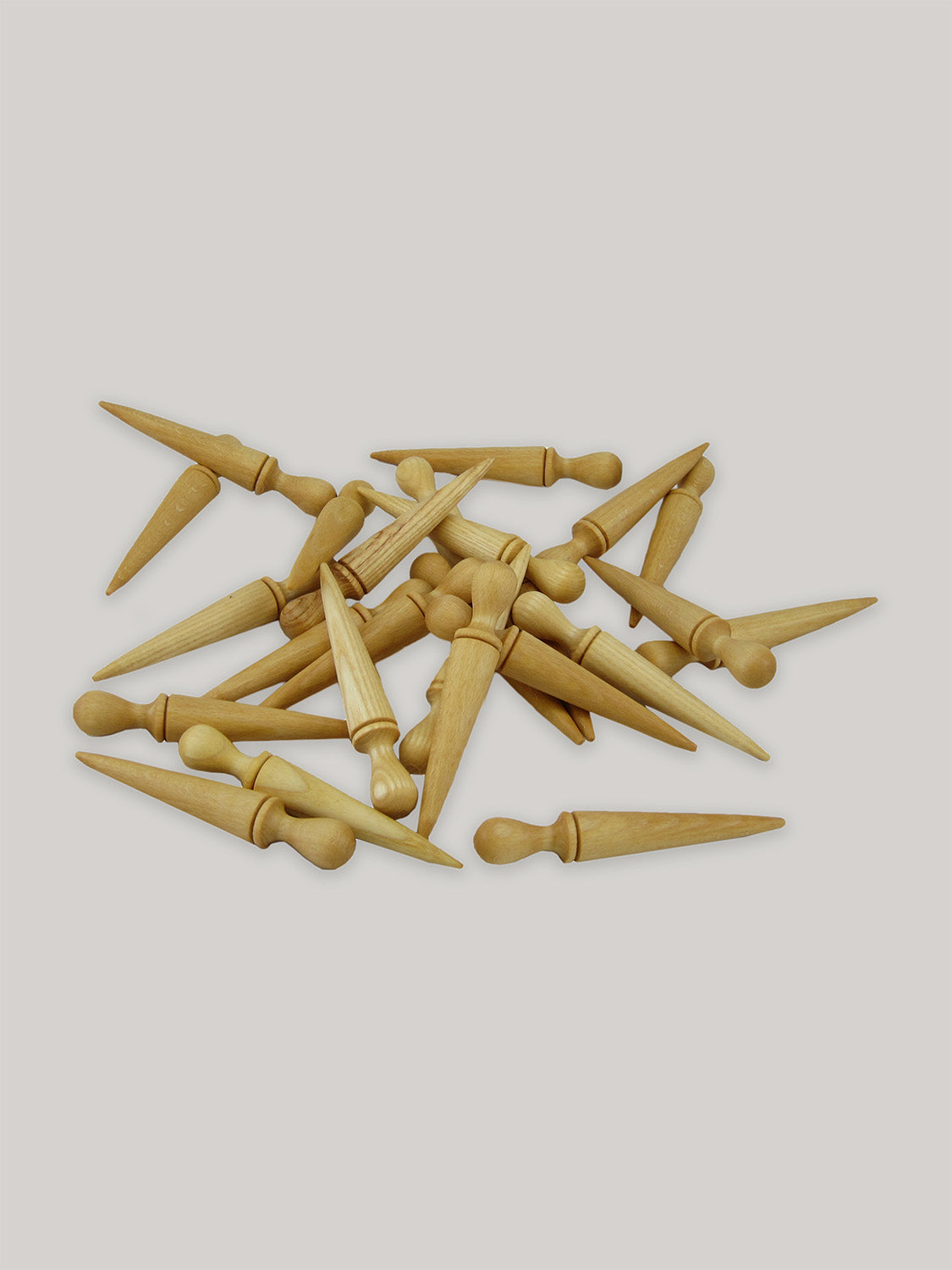 Group of mini beech seed dibbers on a neutral background.