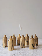 Group of eight miniature wooden bud vases in spalted Beech - front view.