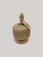 Solid oak twine holder with ball of jute twine and Kraft paper label on a neutral background.