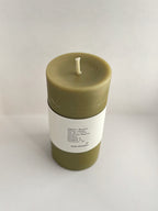 Organic beeswax & green tea pillar candle with label on a neutral background - front view 2.